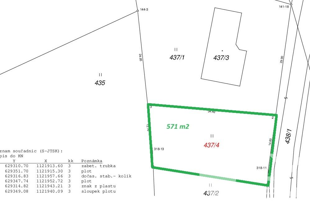 Příjezdová asfaltová komunikace, vpravo živý plot a budoucí vjezd k pozemku